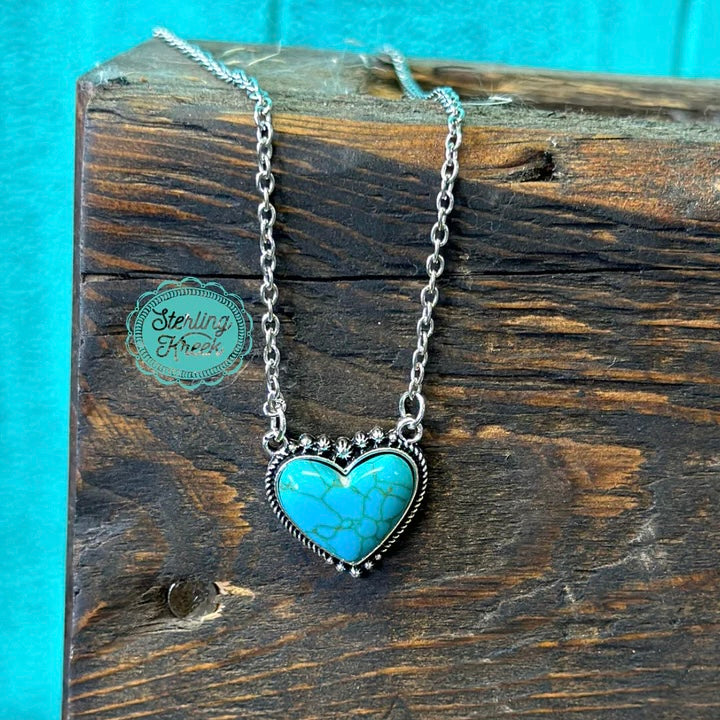 This TURQUOISE HEART is the perfect accessory to spruce up any outfit! Wear it with your most outlandish ensemble and stand out with a pop of color. Show your heart on your sleeve and around your neck, with this eye-catching, statement-making piece!  LENGTH: 11